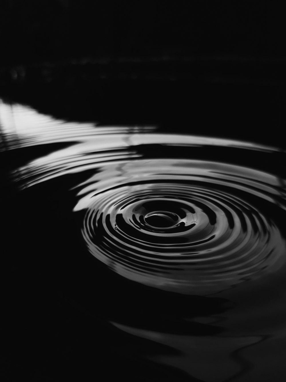 a black and white photo of water ripples