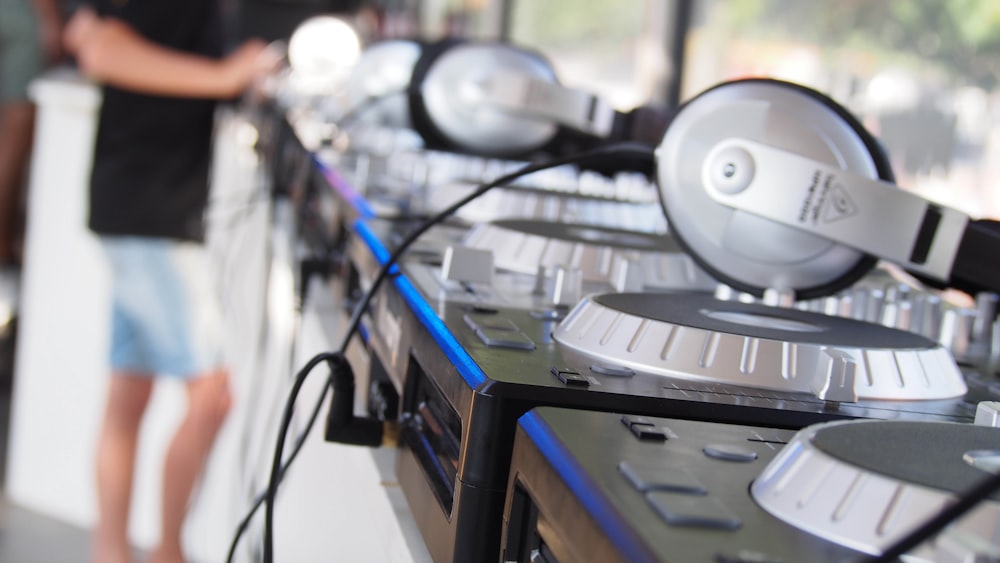 a man standing next to a row of headphones