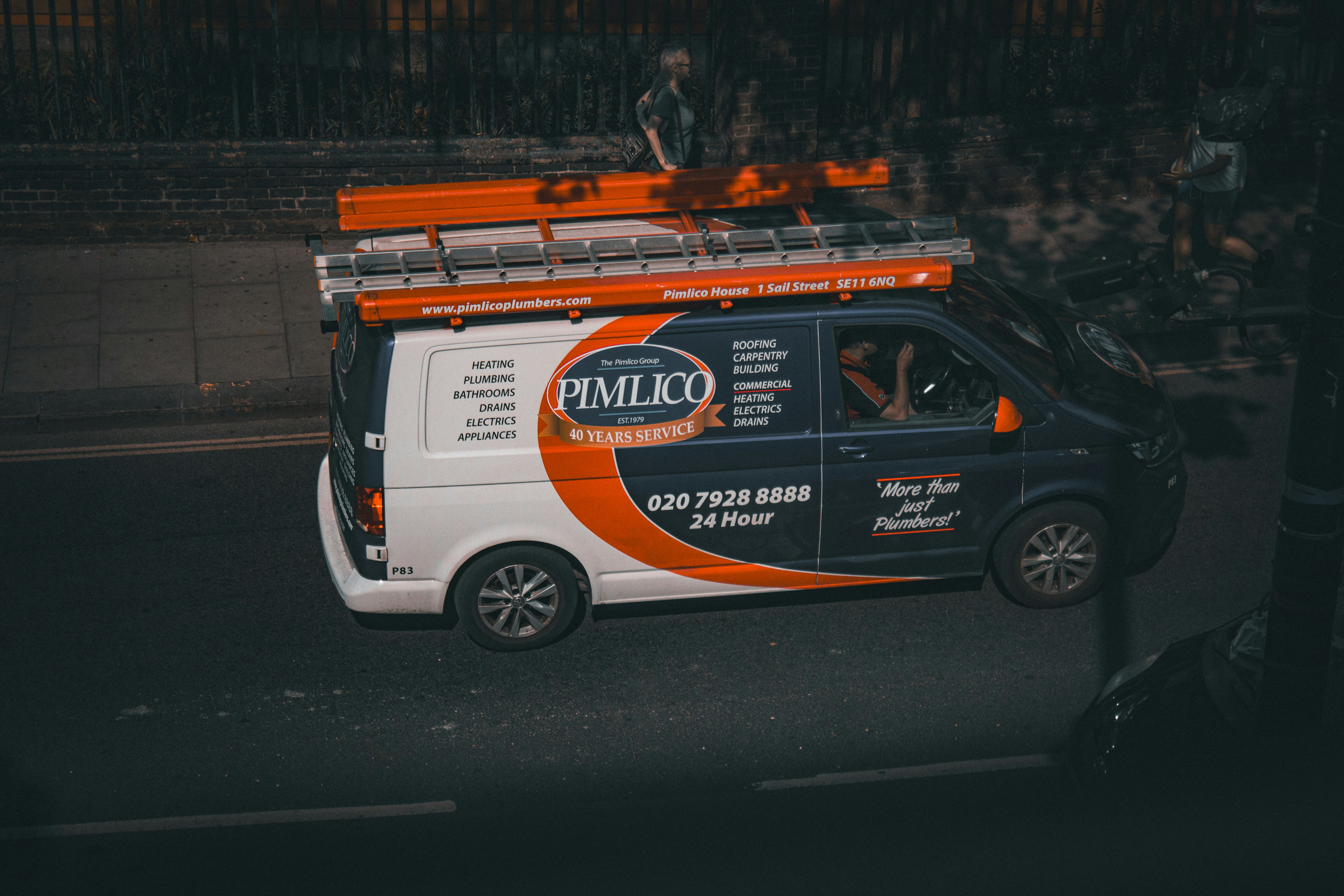 a white van with an orange and black advertisement on the side