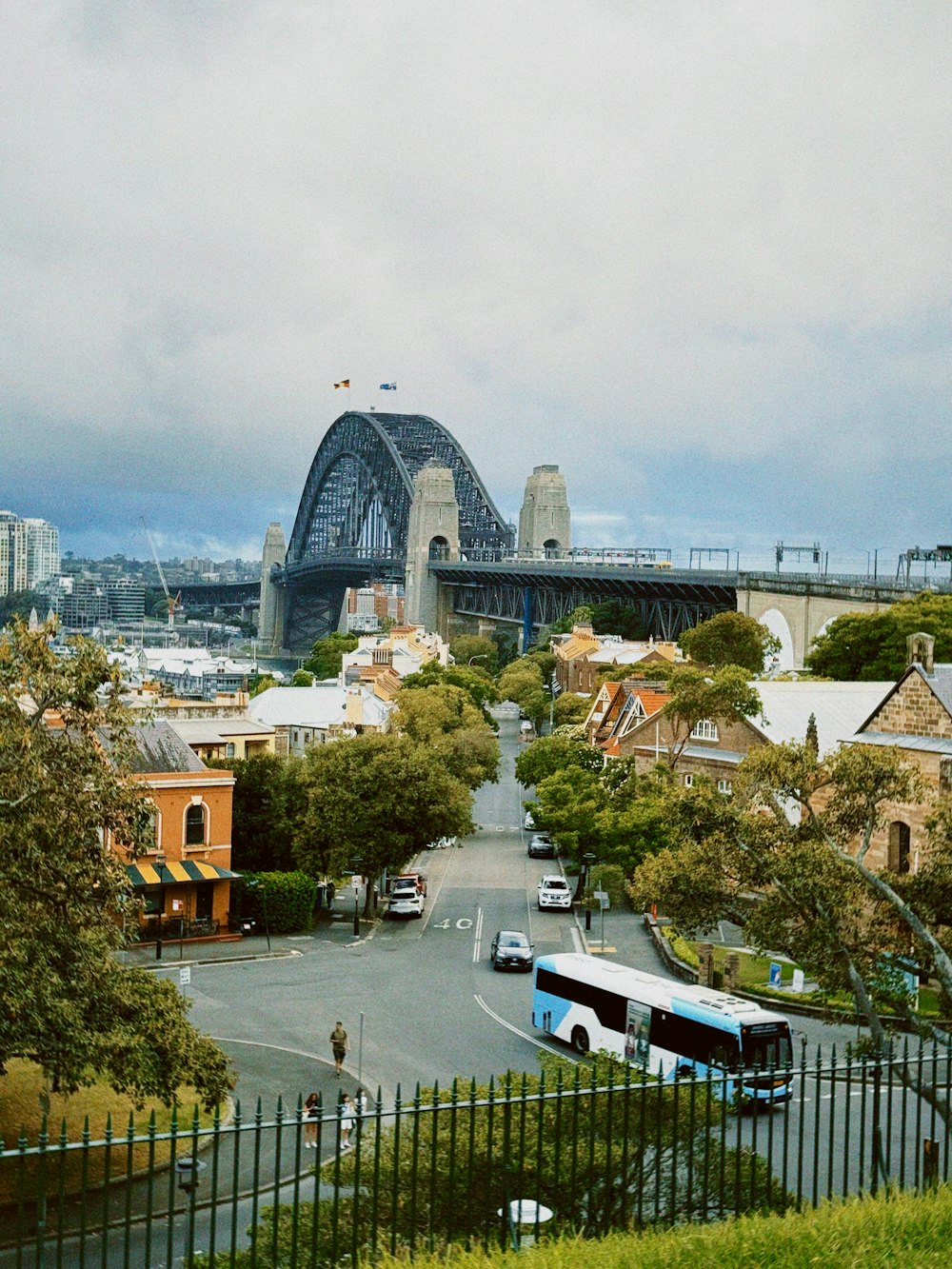 a city street with a bridge in the background