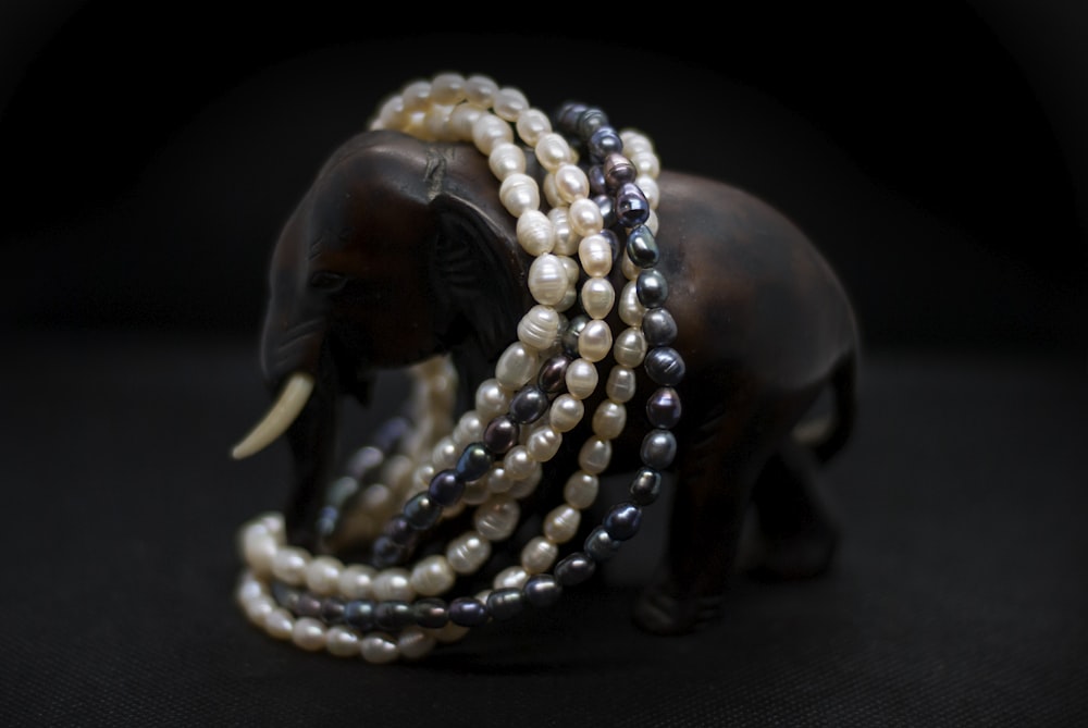 a close up of a bracelet with an elephant on it