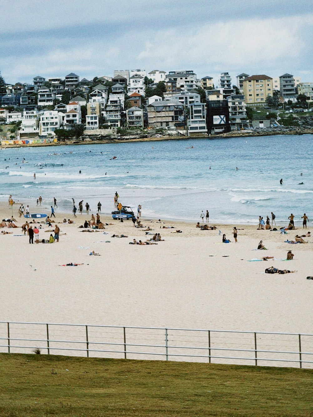 many people are on the beach near the water