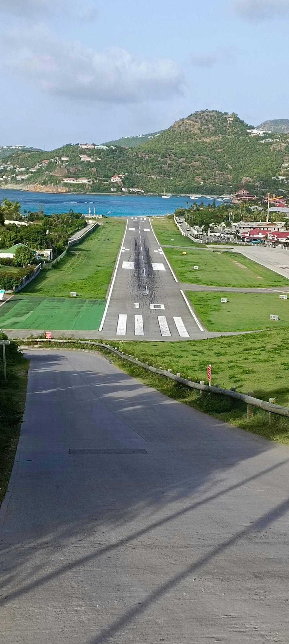 an airport runway with a plane on the runway