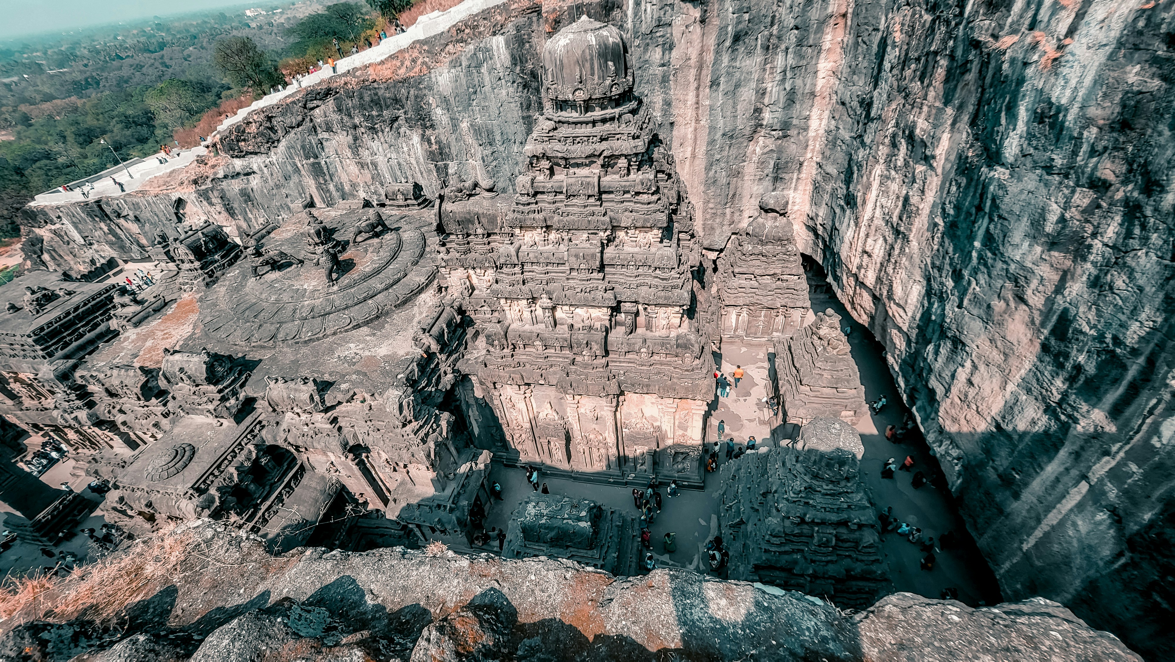 Ancient stone temple with researchers using digital scanning equipment and laptops