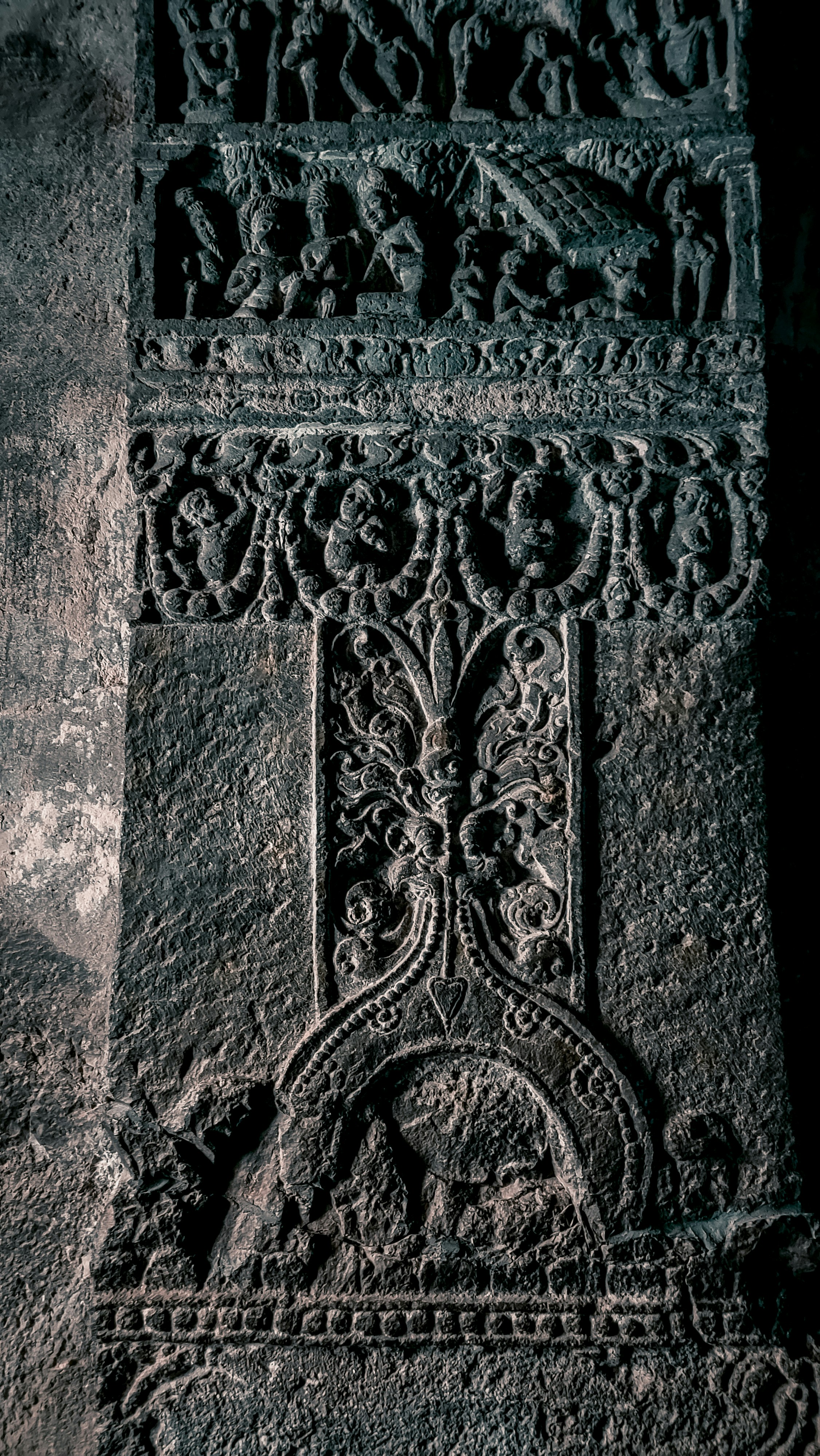 a close up of a stone wall with carvings on it
