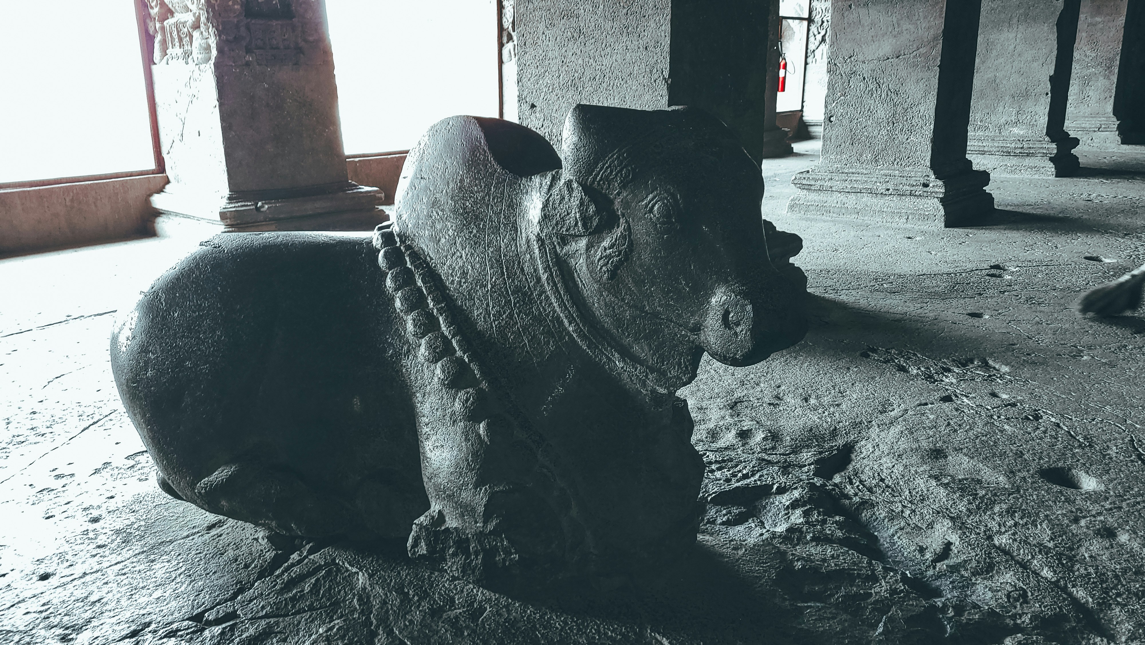 a black and white photo of a statue of a dog
