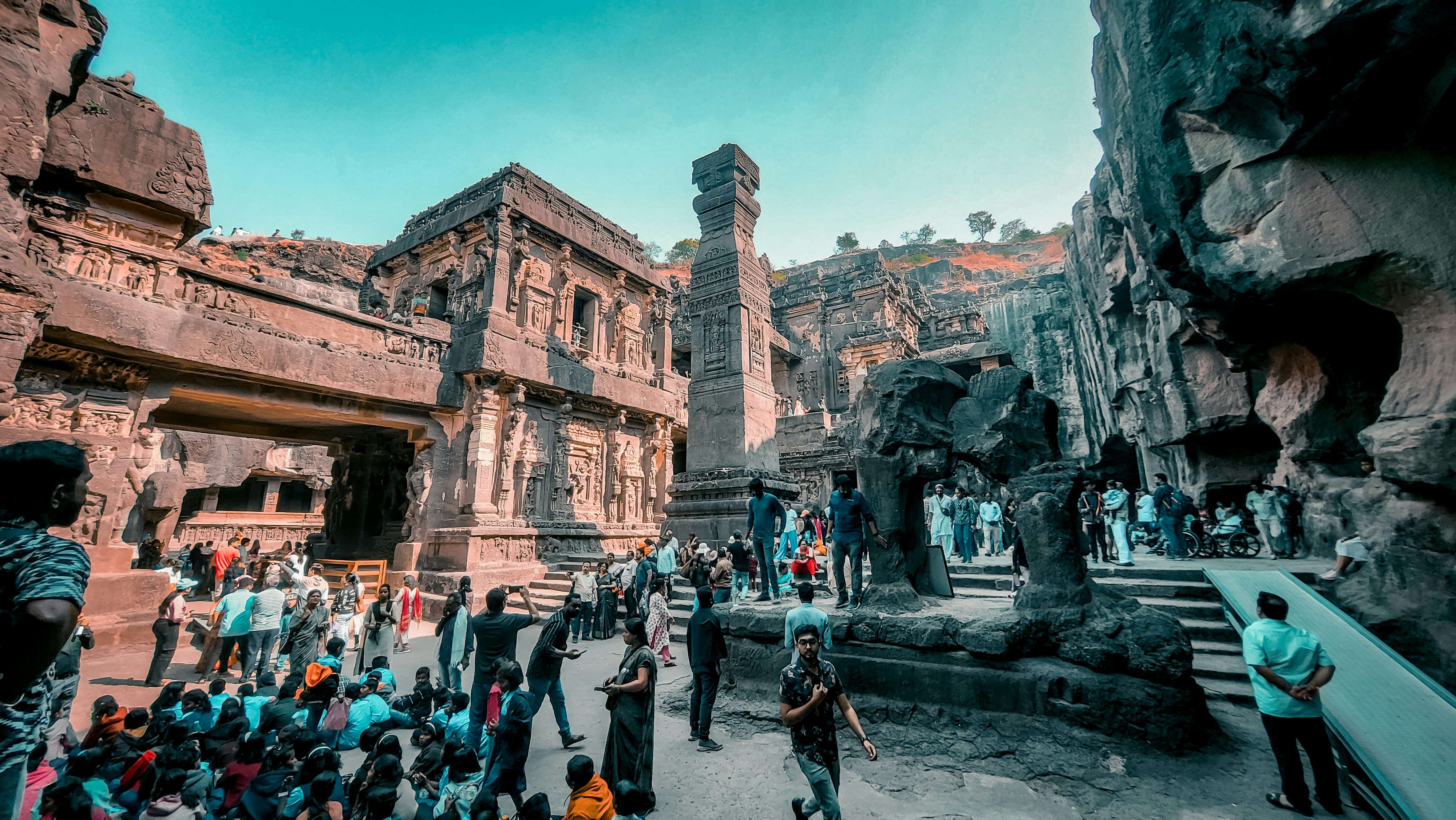 a crowd of people standing around a stone building