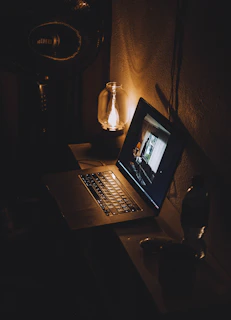 a laptop computer sitting on top of a wooden desk