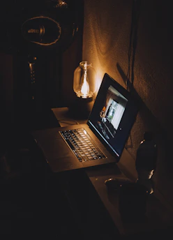 a laptop computer sitting on top of a wooden desk