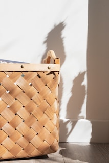 a wooden basket sitting on top of a wooden floor