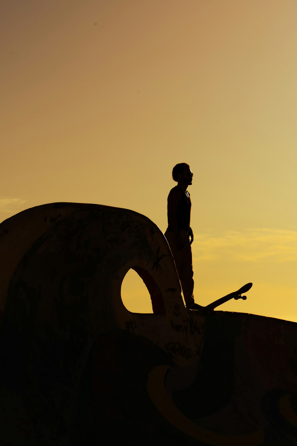 a person with a skateboard standing on a ramp