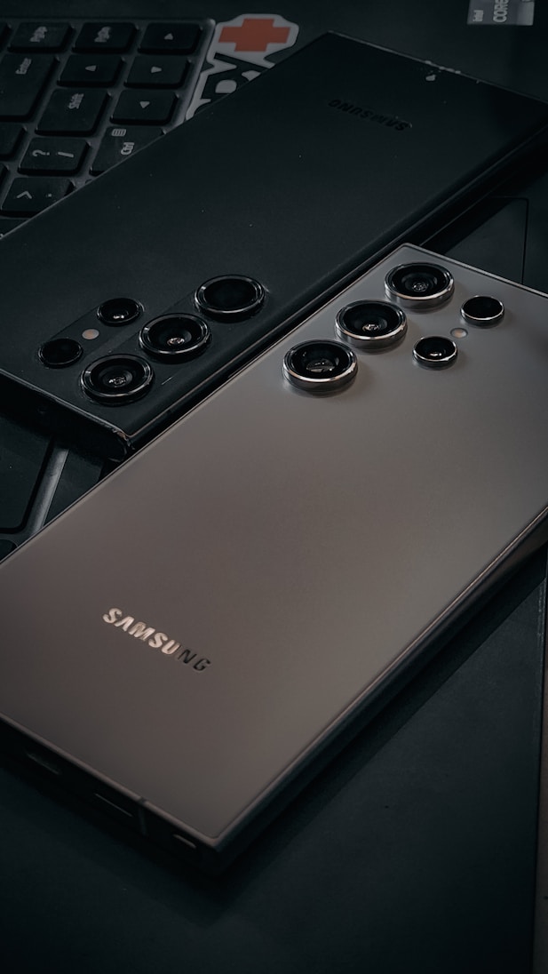 a close up of a cell phone near a keyboard