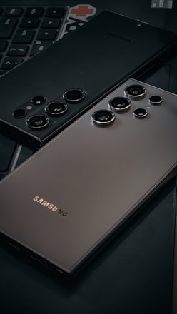 a close up of a cell phone near a keyboard