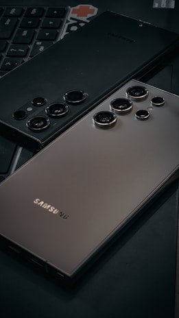 a close up of a cell phone near a keyboard