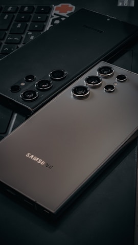 a close up of a cell phone near a keyboard