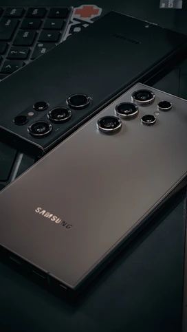 a close up of a cell phone near a keyboard