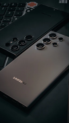 a close up of a cell phone near a keyboard