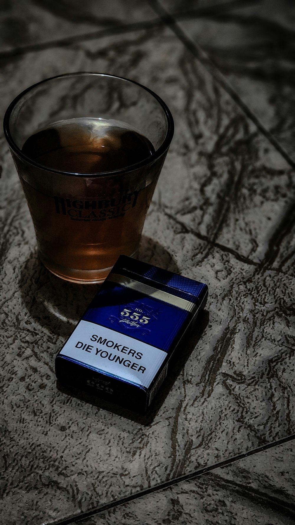 a glass of tea next to a cigarette