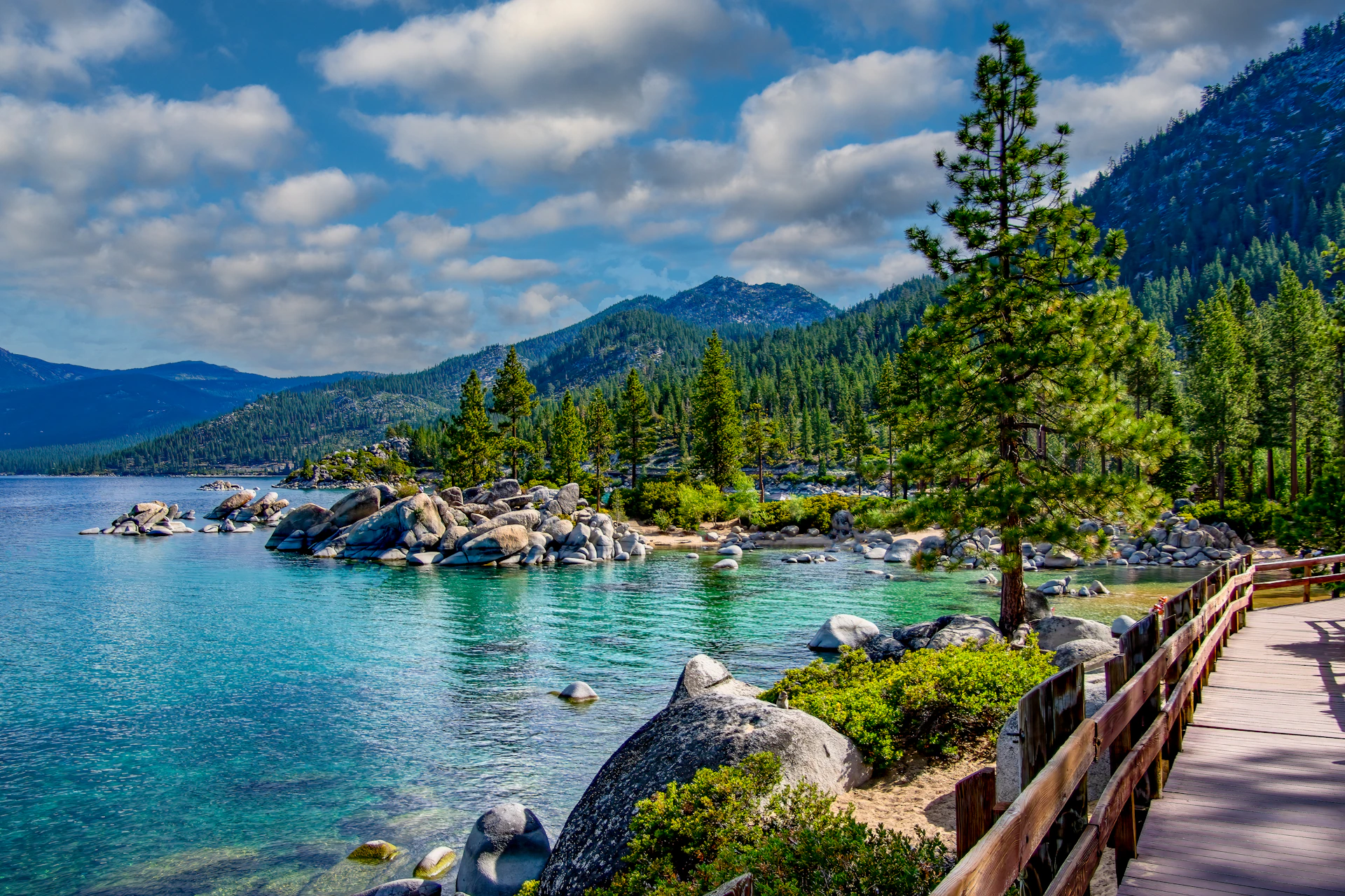 a scenic view of a lake surrounded by mountains