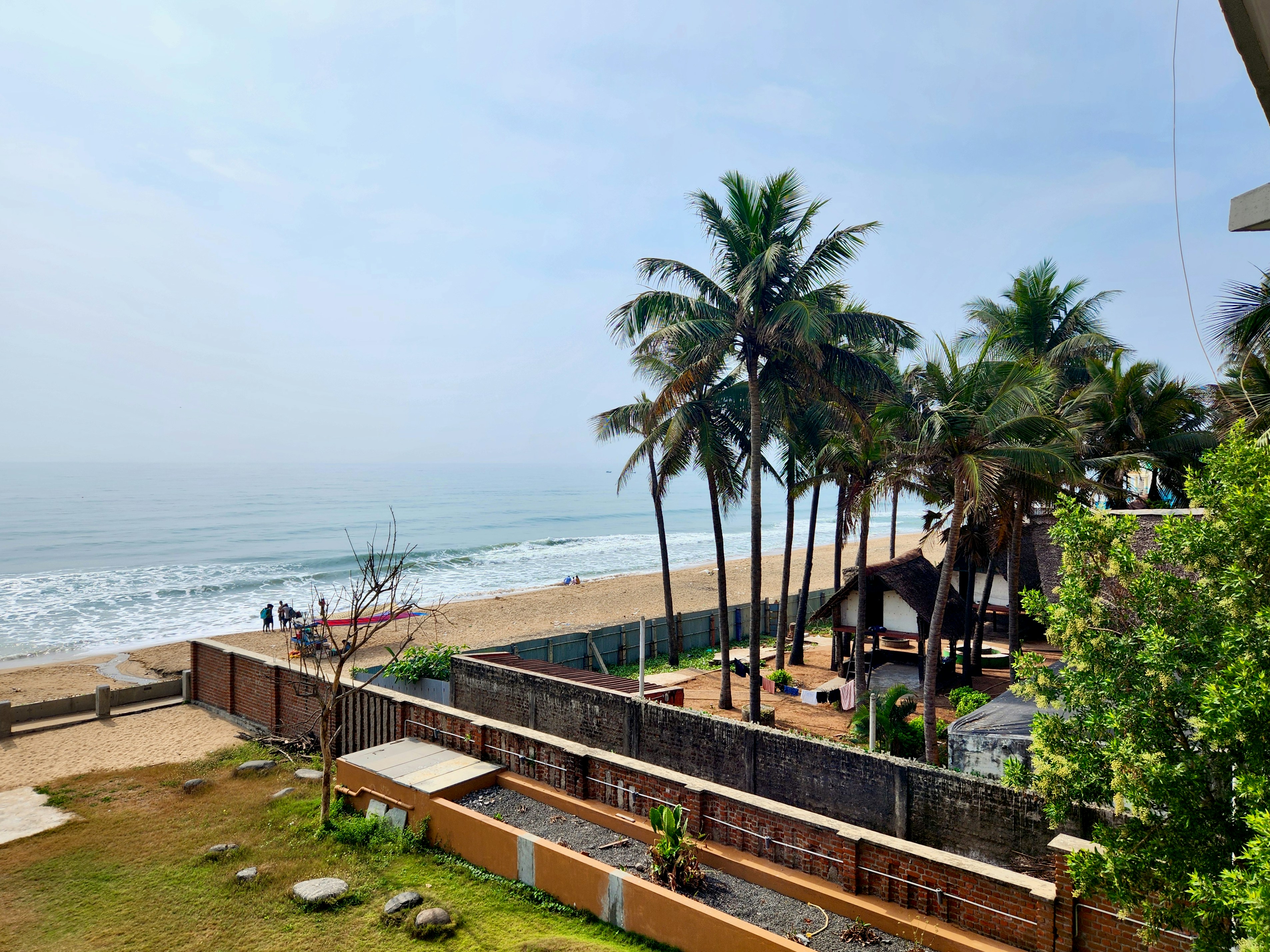a view of a beach with palm trees in the foreground, Sea View from Ostel.in