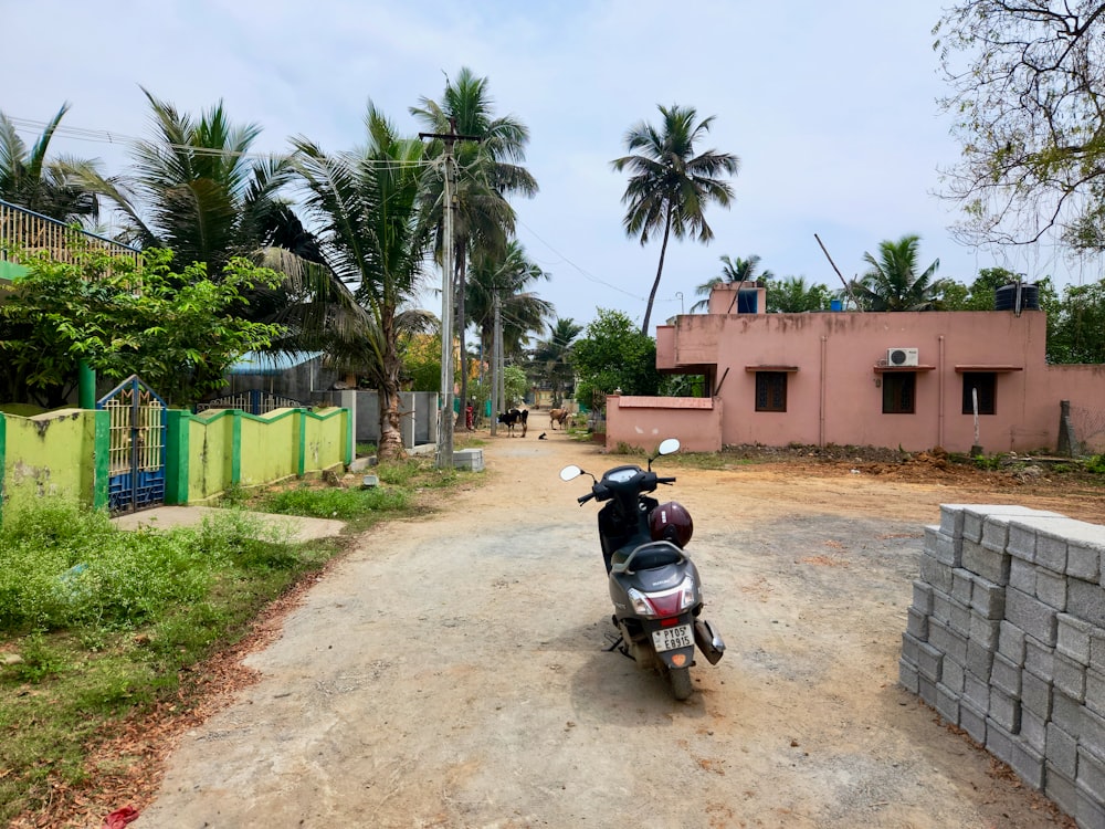 a motorcycle parked on the side of a dirt road