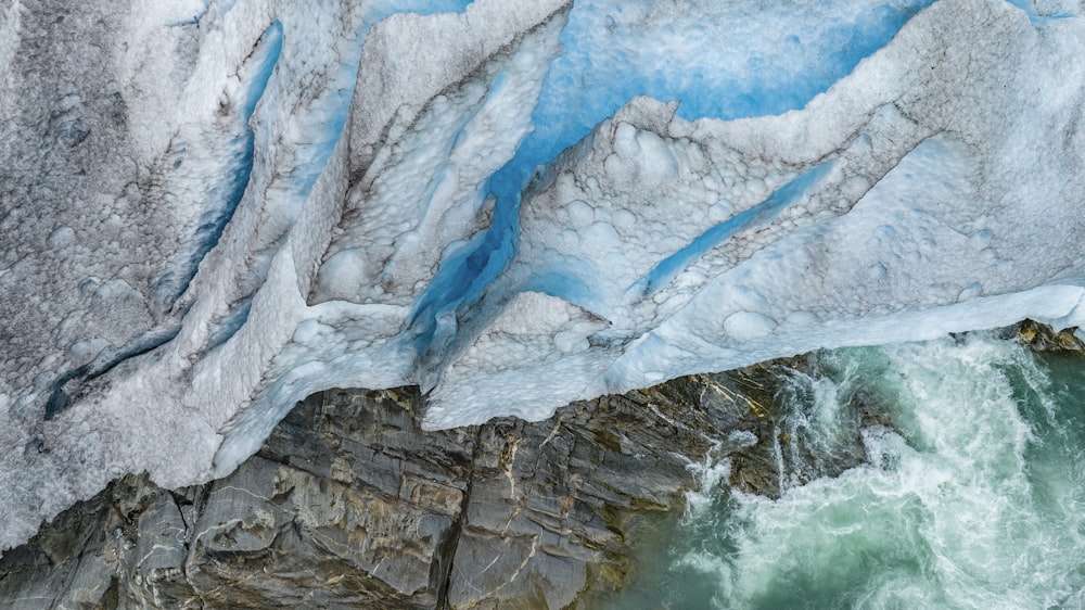 an aerial view of a glacier and a body of water