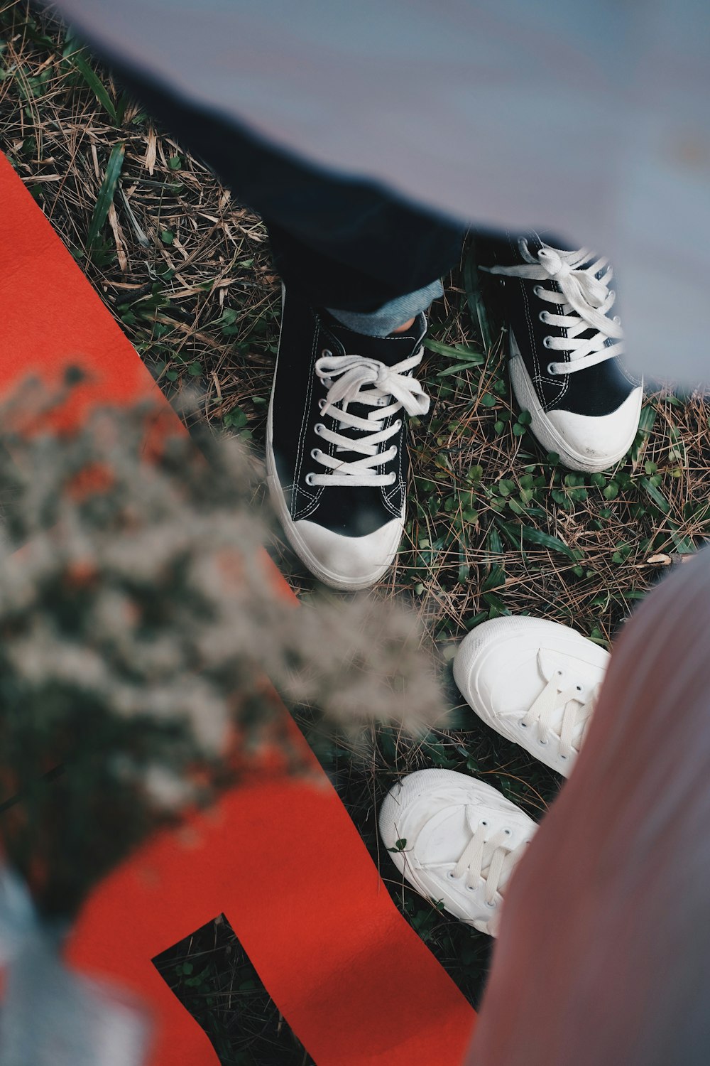 a pair of black and white shoes sitting on the ground