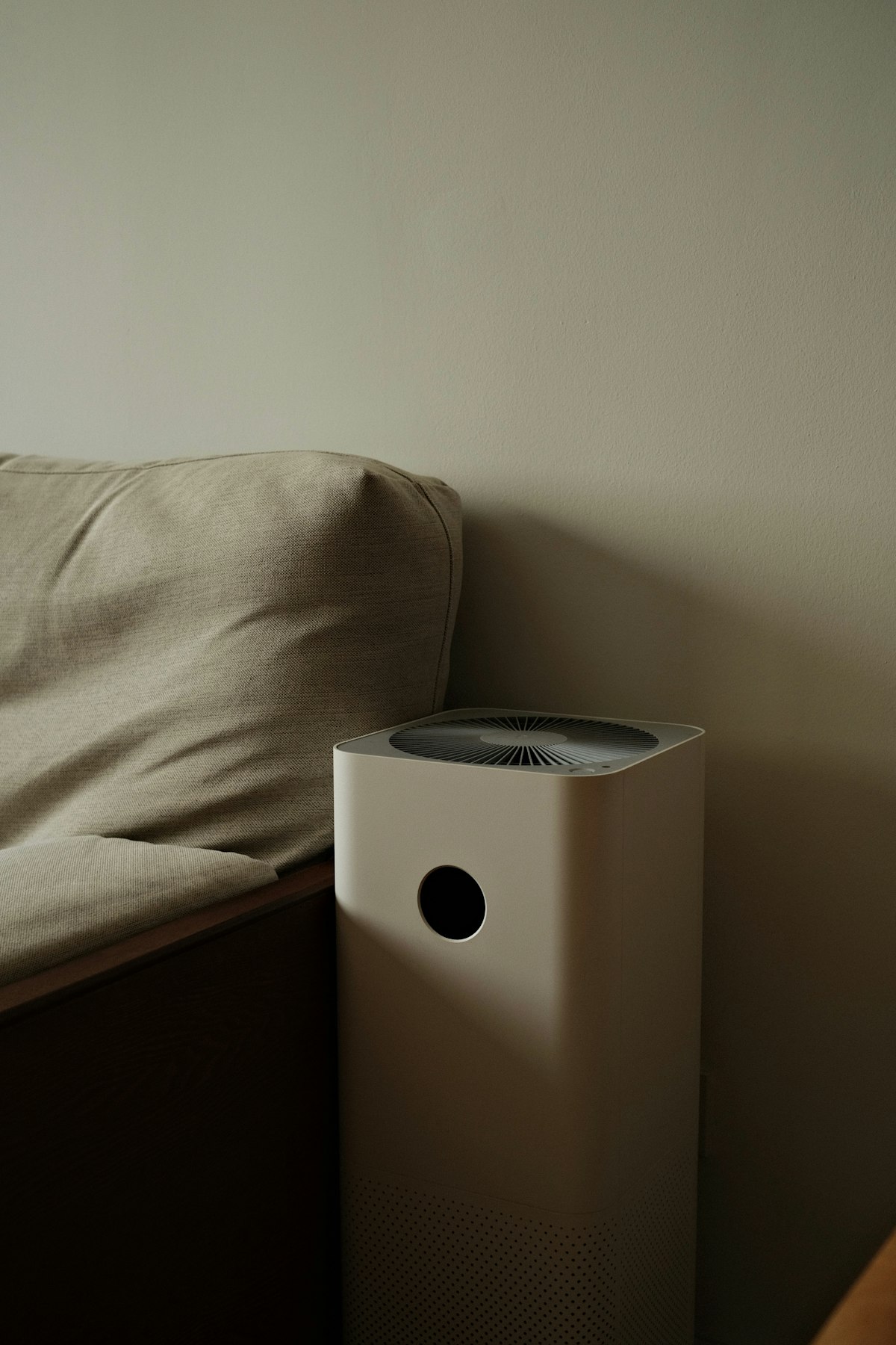 White appliance sitting on a bed in a bright room