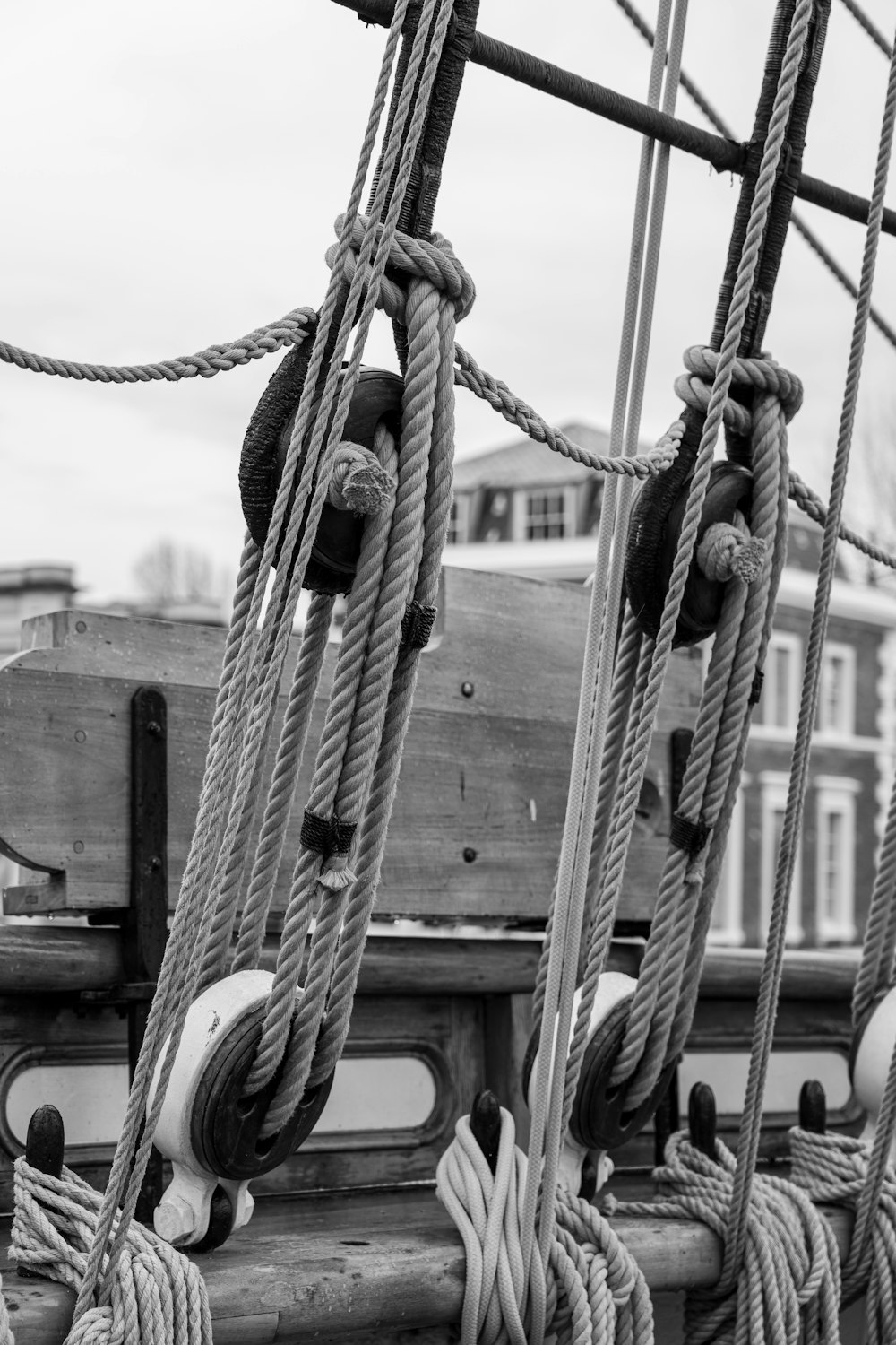 a black and white photo of ropes on a boat