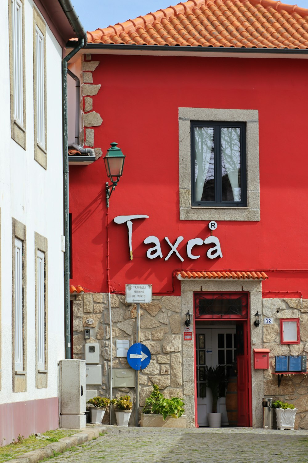 a red building with a sign that says taxca