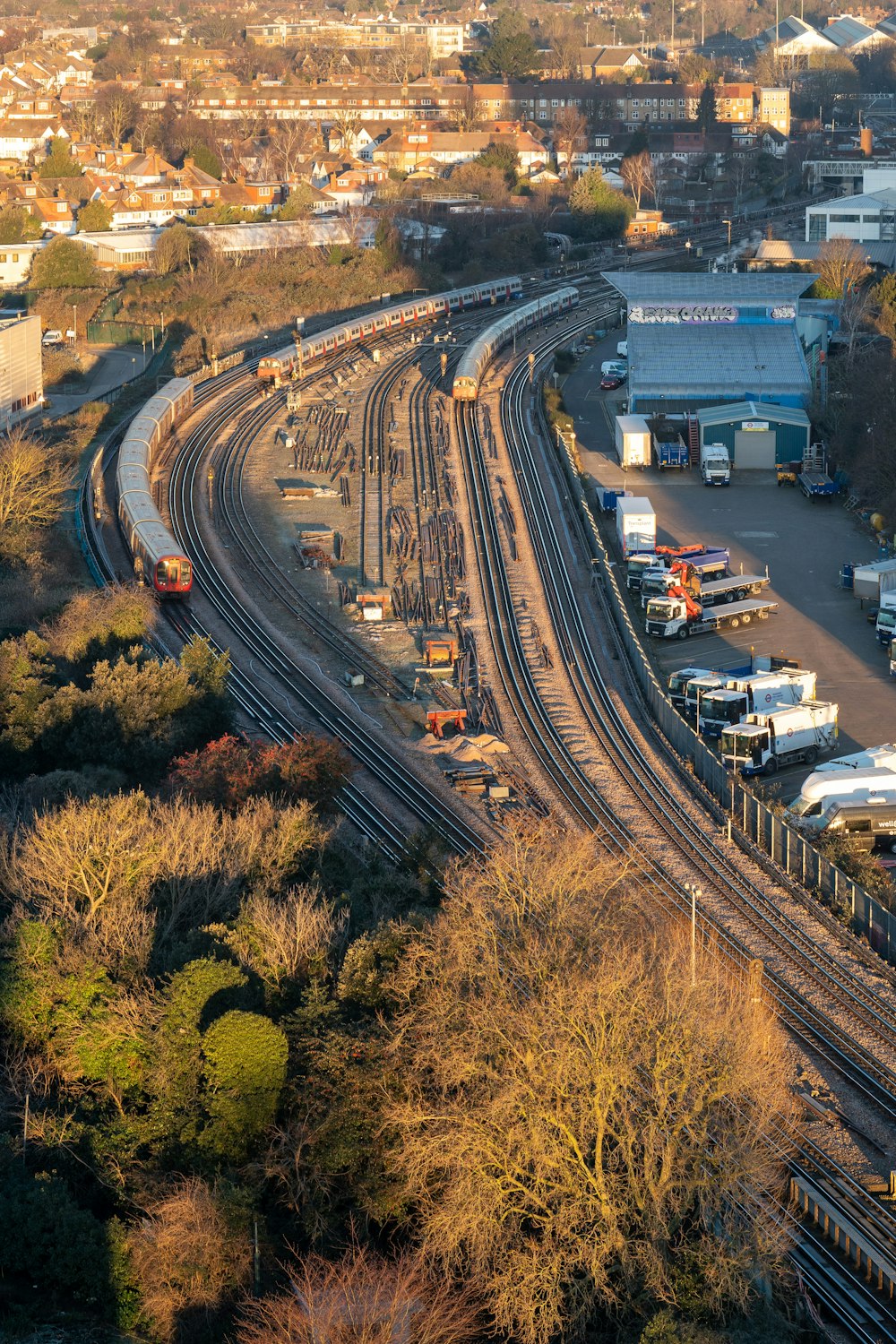 an aerial view of a train yard with a train on the tracks