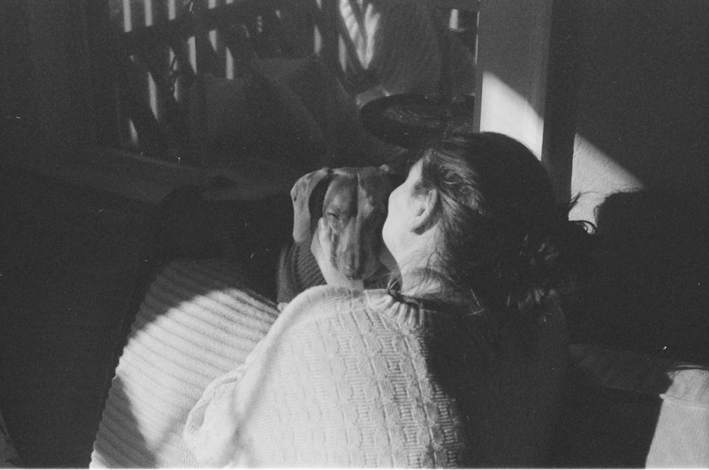 a black and white photo of a woman laying in bed