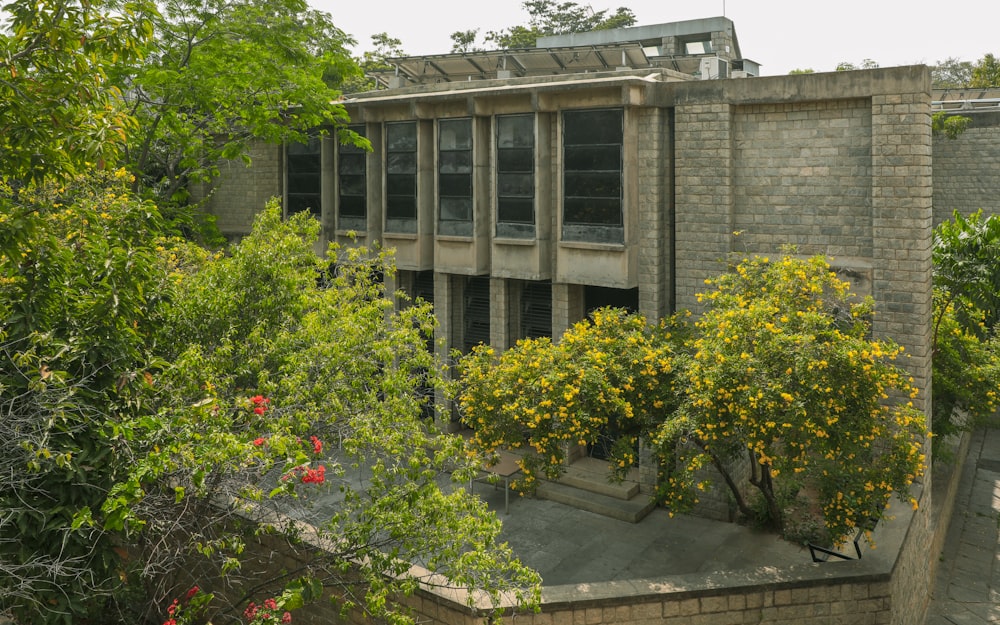 a building with a lot of windows surrounded by trees