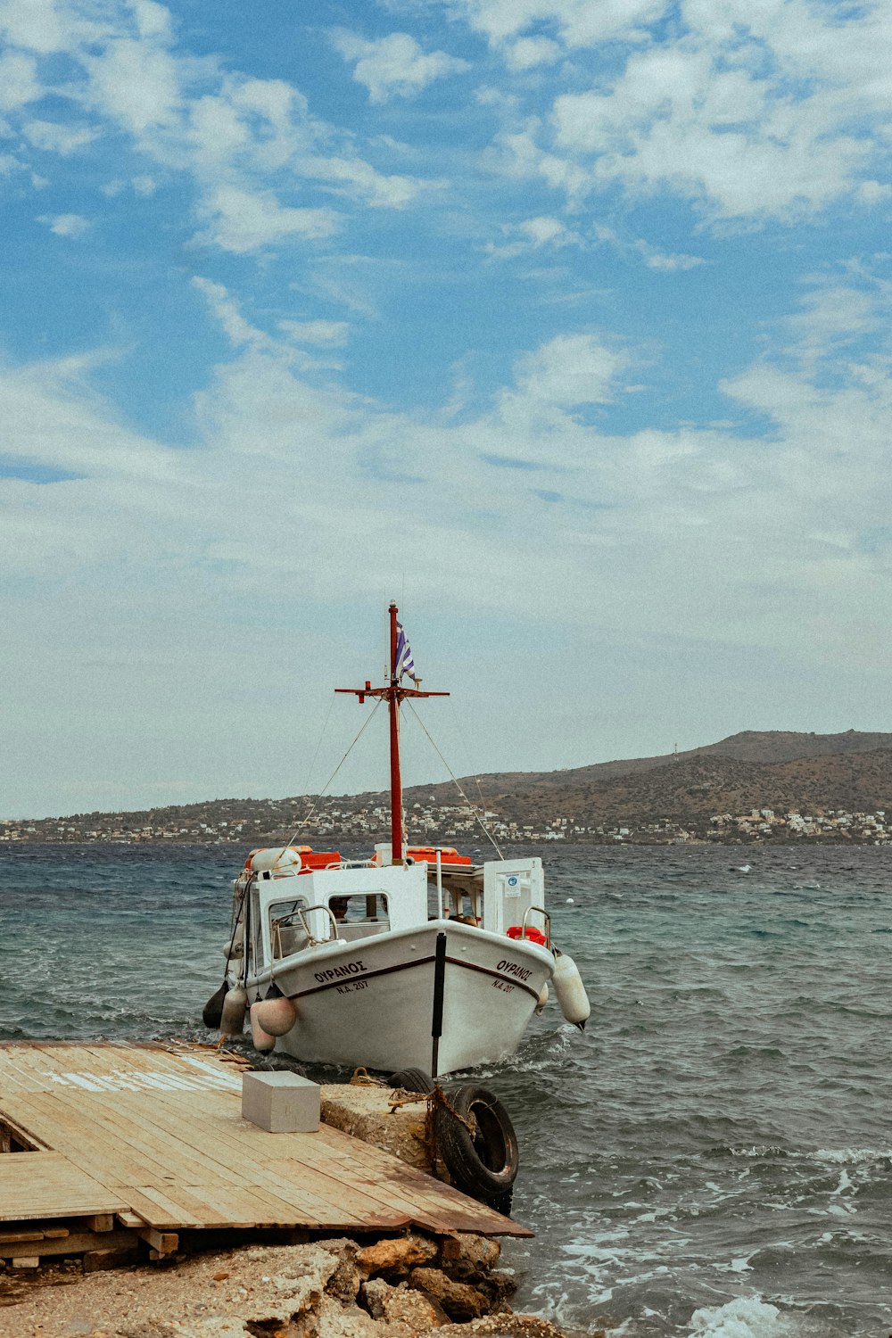 a small boat sitting on top of a body of water