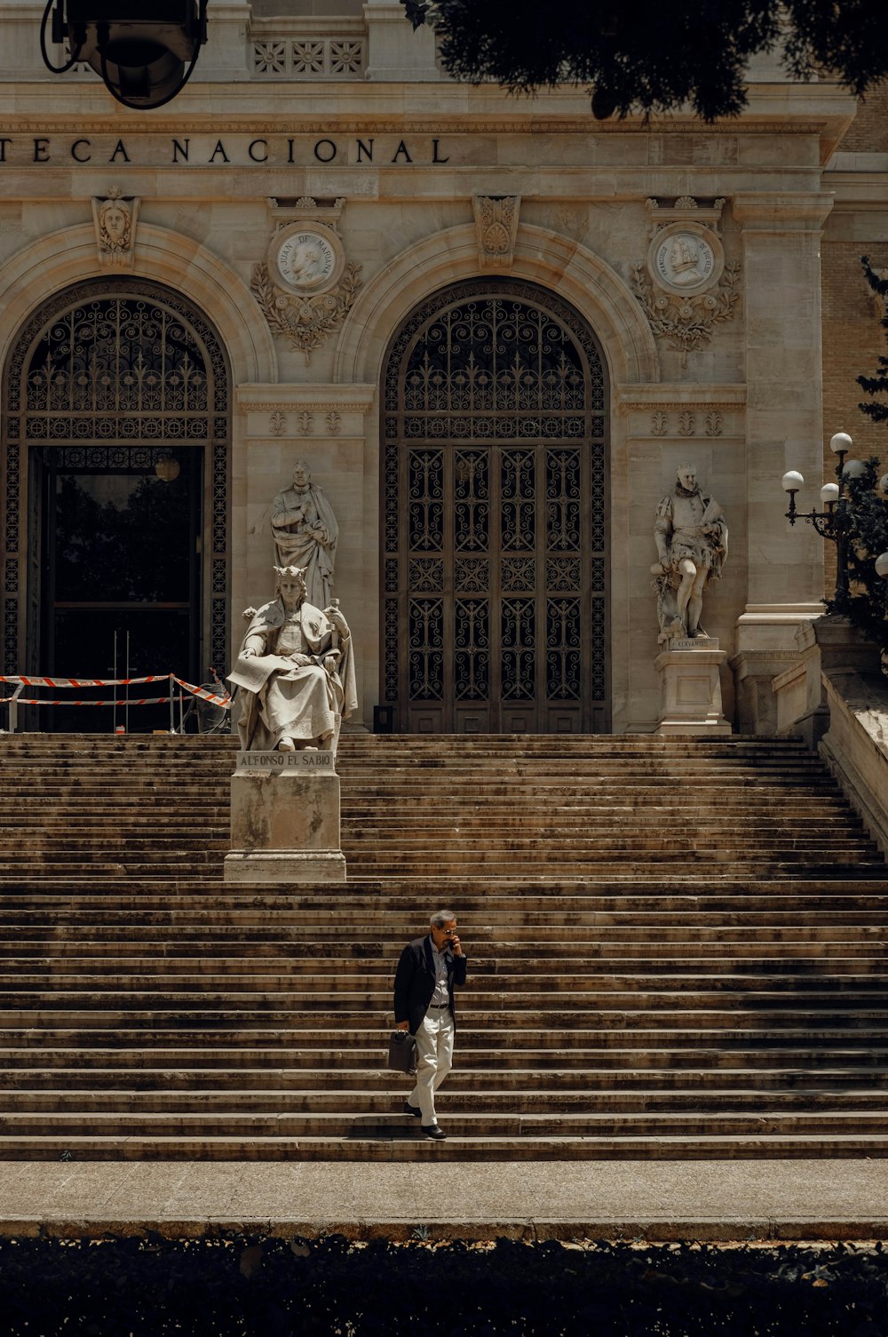 a man walking down a set of steps in front of a building