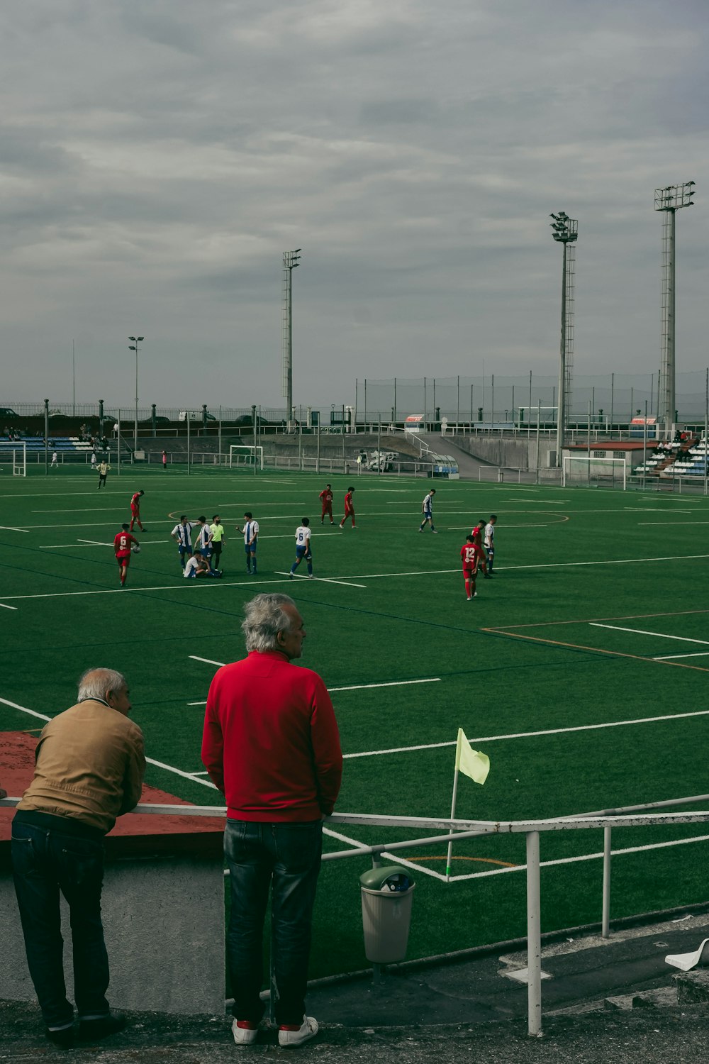 a group of people standing on top of a soccer field