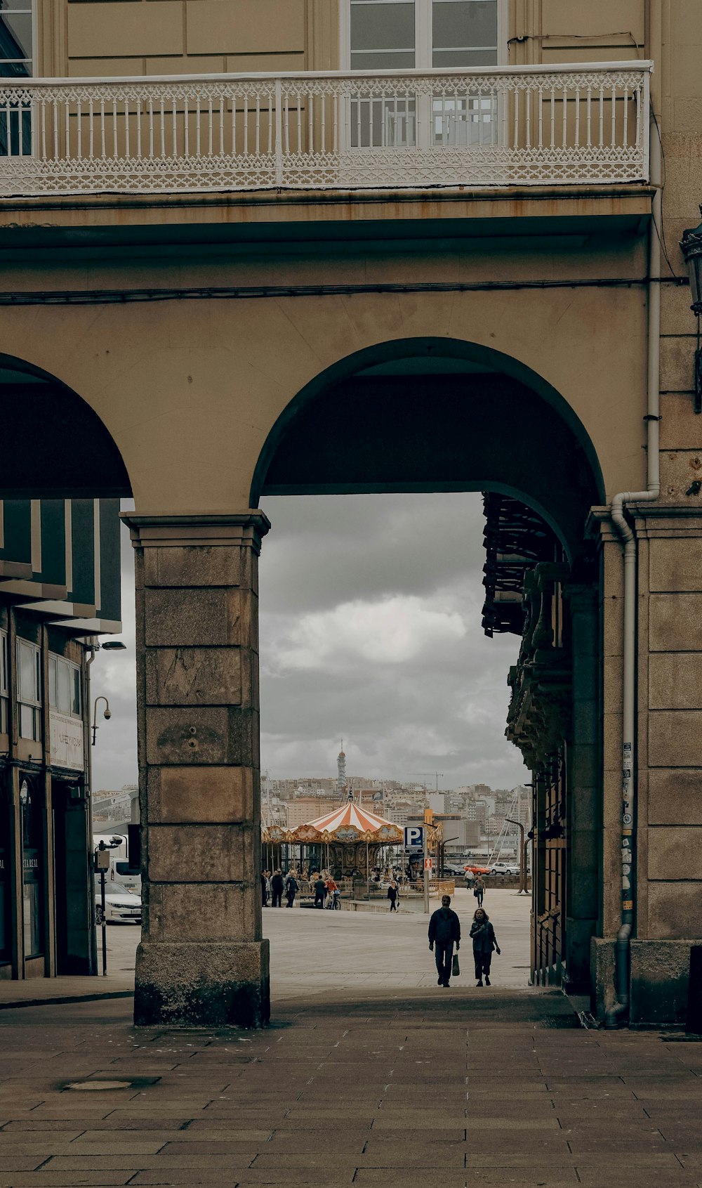 a couple of people that are walking under a bridge