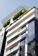 a very tall building with a bunch of plants on the top of it