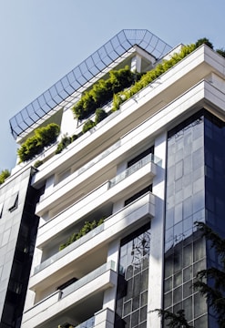 a very tall building with a bunch of plants on the top of it
