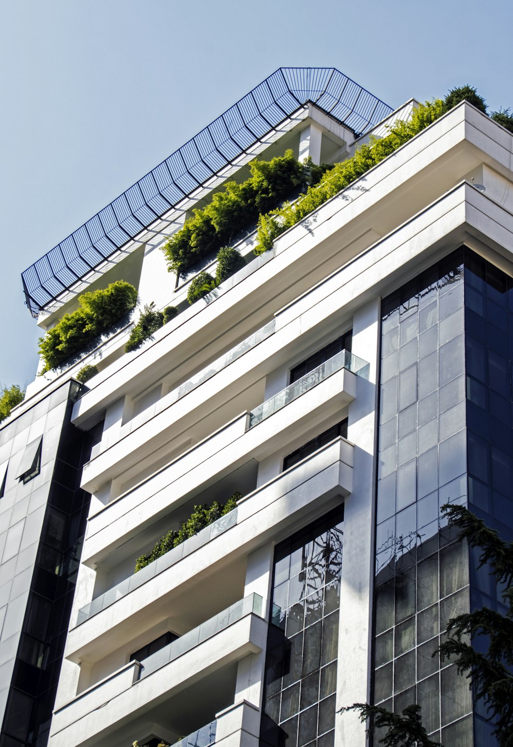 a very tall building with a bunch of plants on the top of it