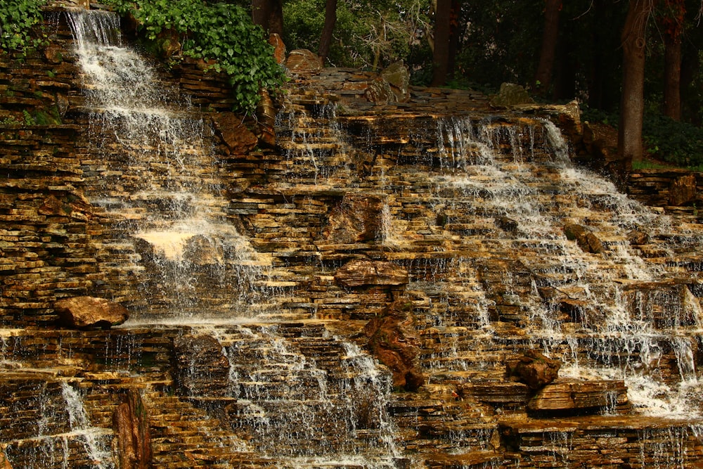 a large waterfall in the middle of a forest