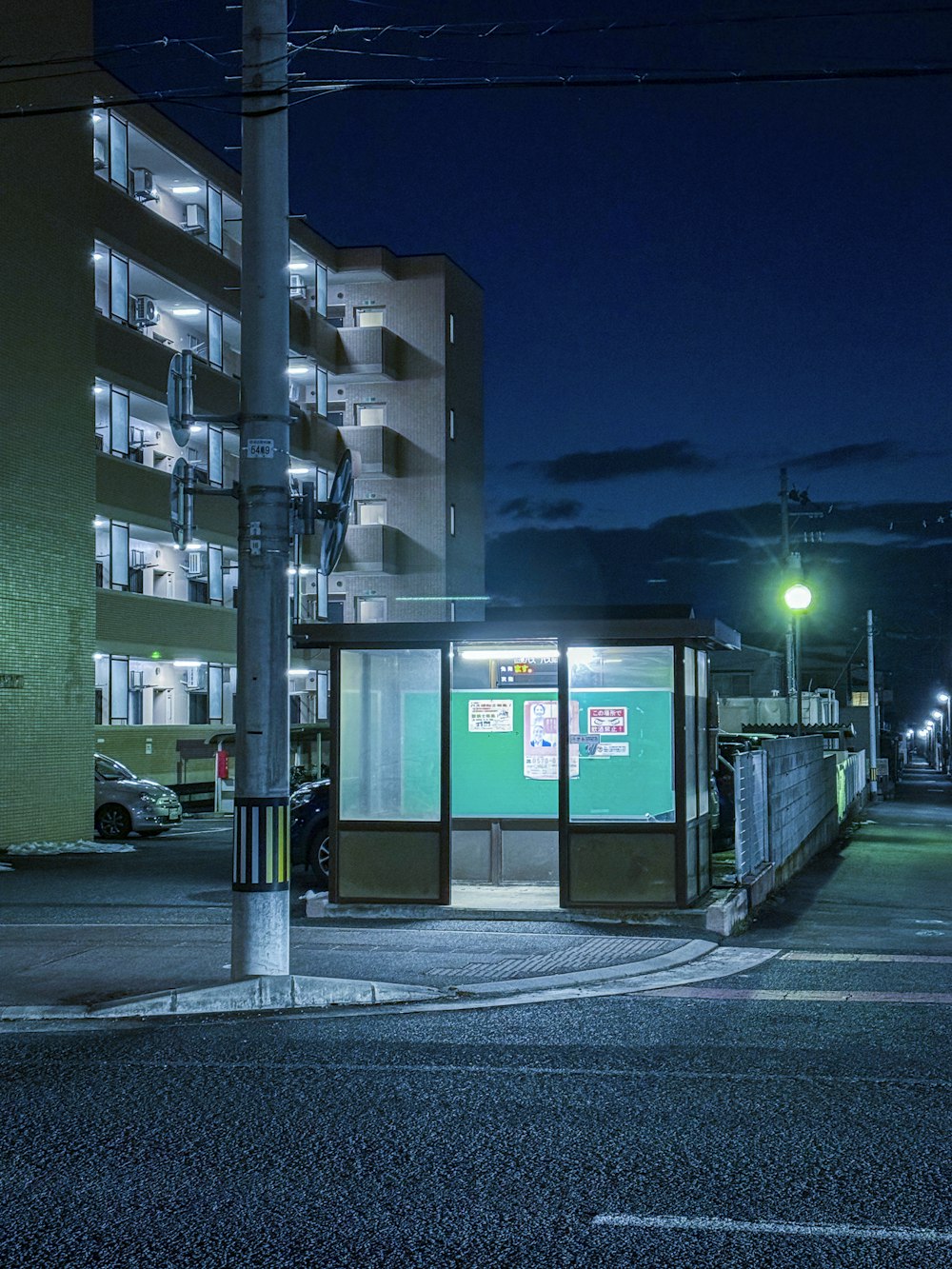 a bus stop sitting on the side of a road