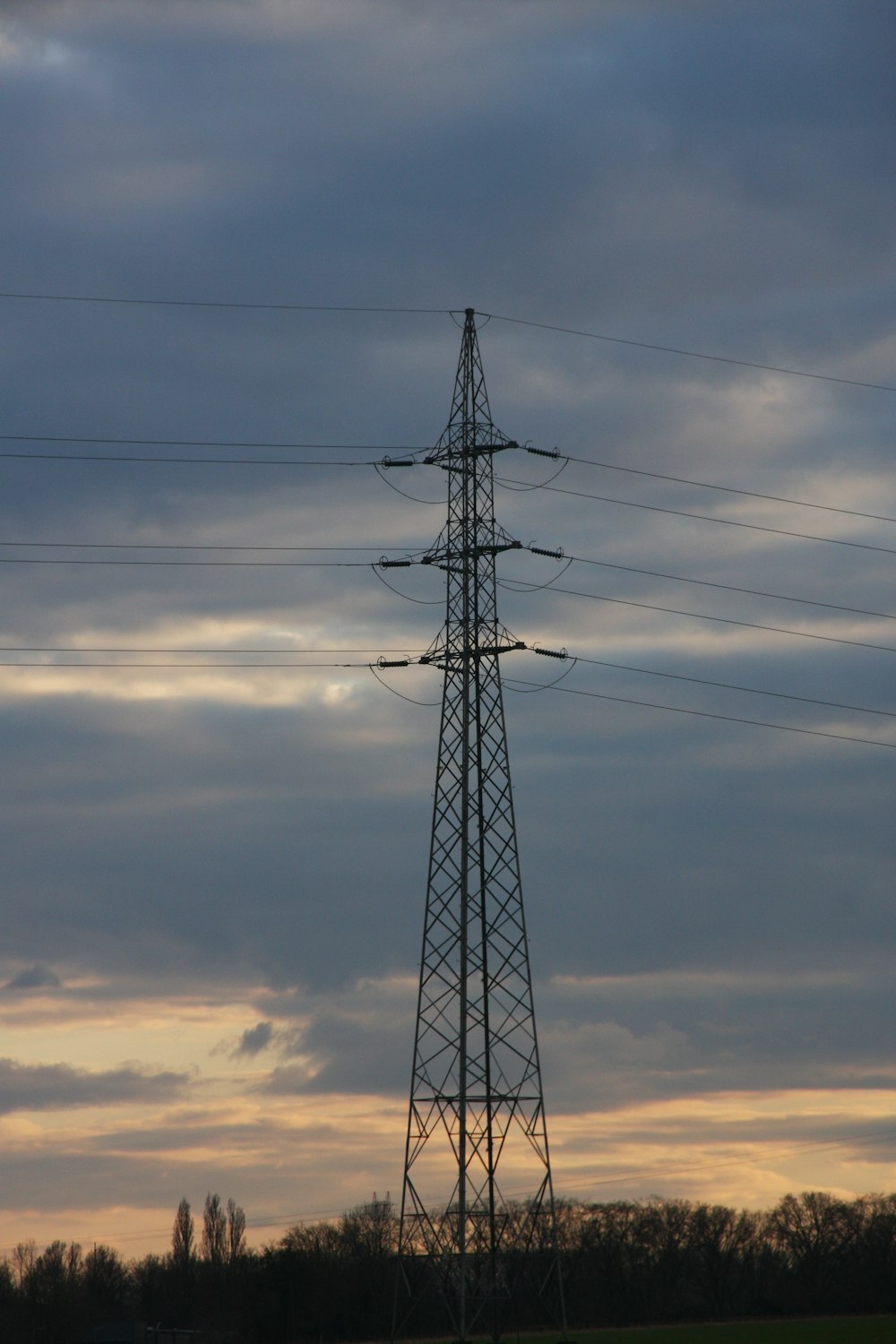 a tall tower with power lines on top of it
