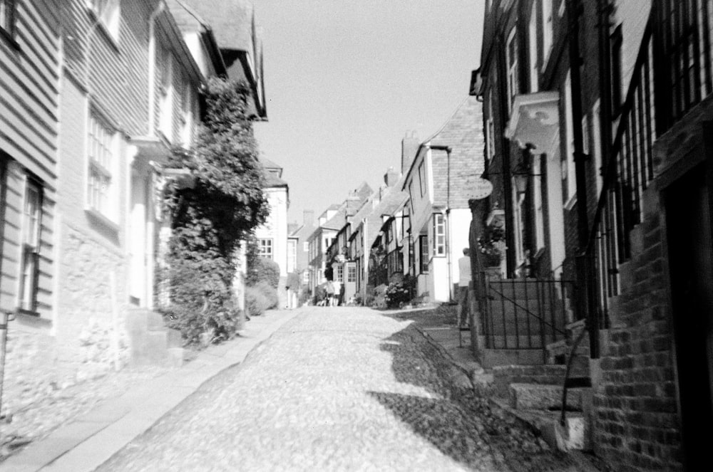 a black and white photo of a narrow street