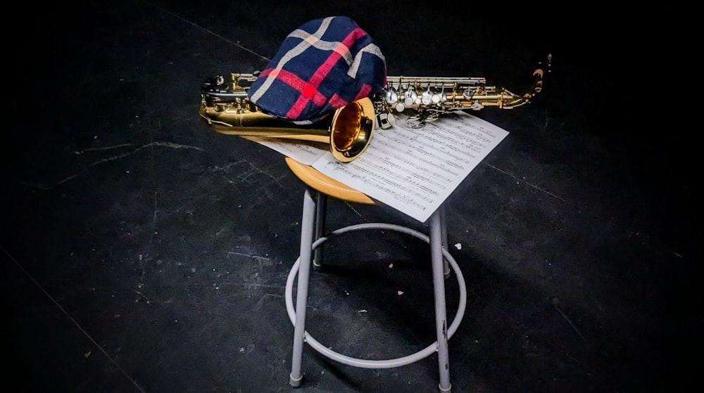 a saxophone sitting on top of a table next to a sheet of paper
