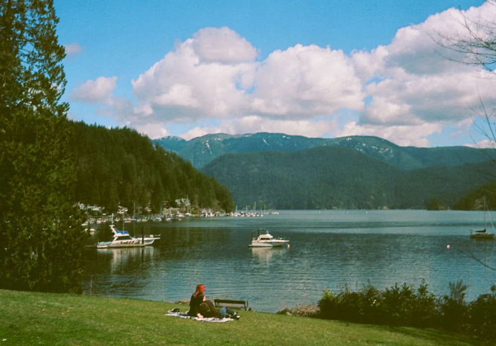 a person sitting on a bench near a body of water