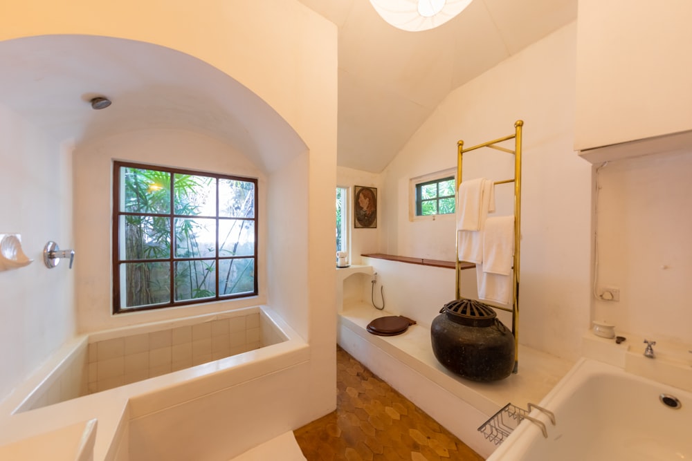 a bathroom with a tub, sink, and window