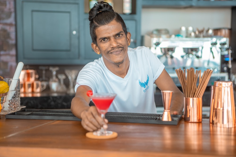 a man sitting at a bar with a drink