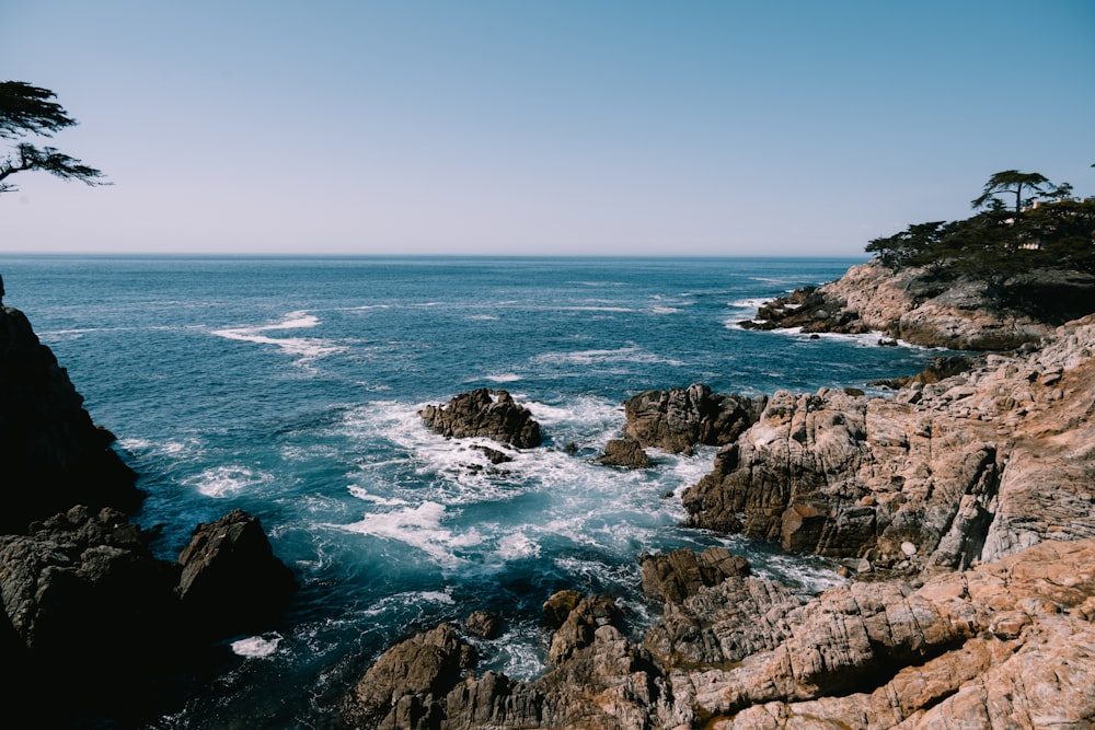 a person standing on a cliff overlooking the ocean