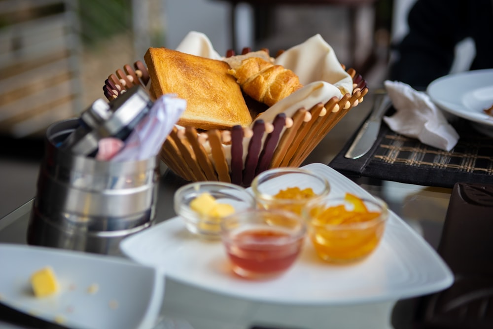 a table topped with plates and cups filled with food